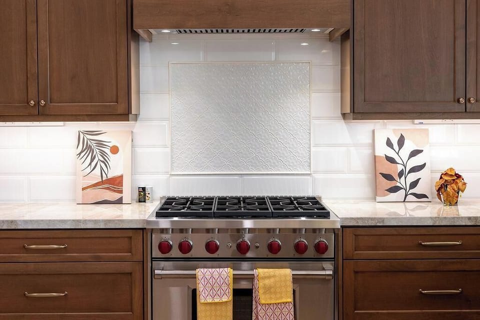 Modern kitchen with high-end appliances and elegant marble countertops.