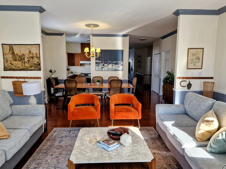 Large living room with two 3-seater sofas and two arm chairs