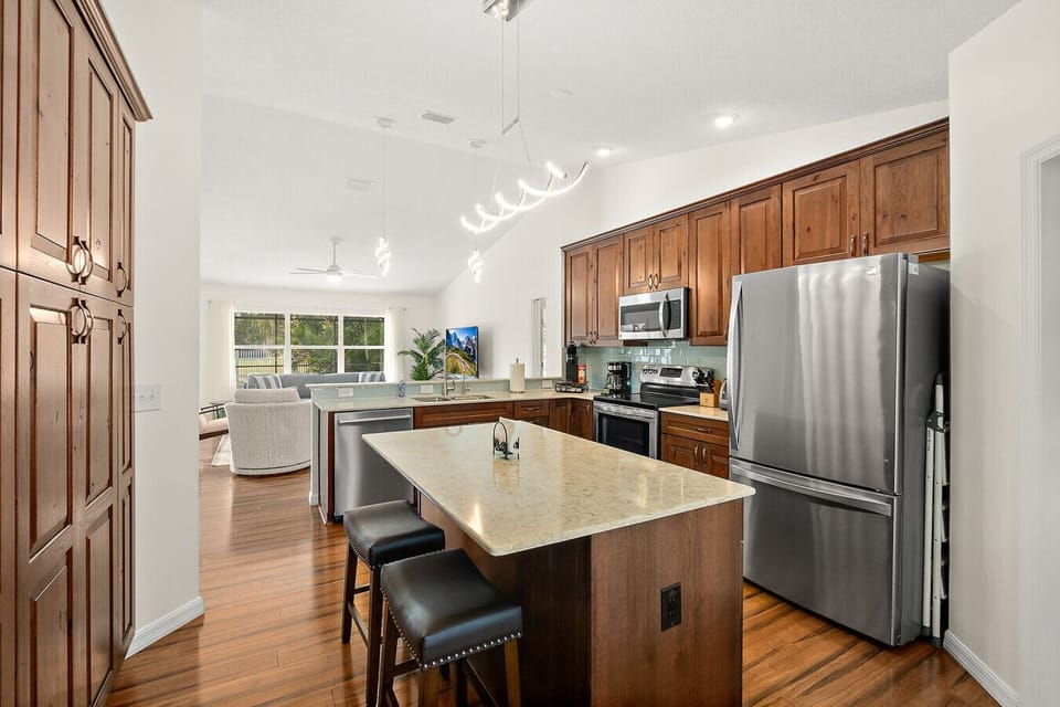 Spacious kitchen with granite island and stainless appliances