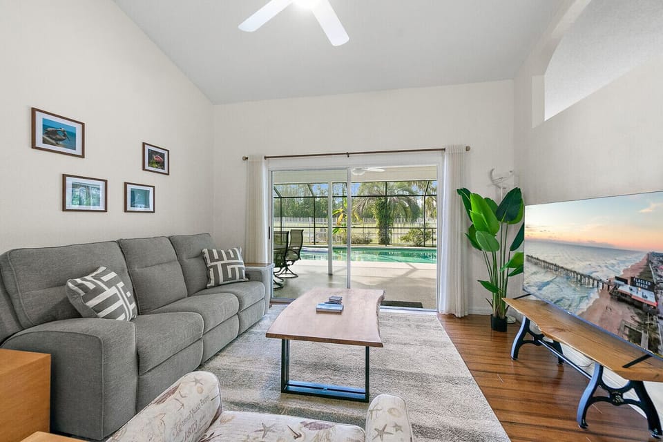 Comfortable living room with pool views and natural light