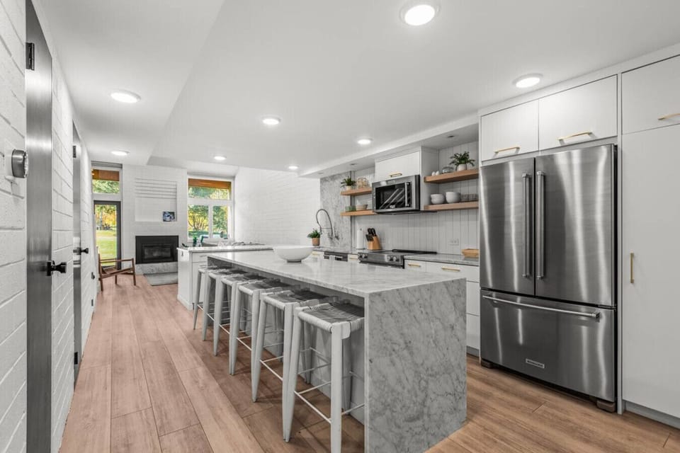 Large kitchen perfect for preparing meals or plating take out. Bar seating for 5 at the kitchen island and 5 additional bar seats at the kitchen bar near the living room