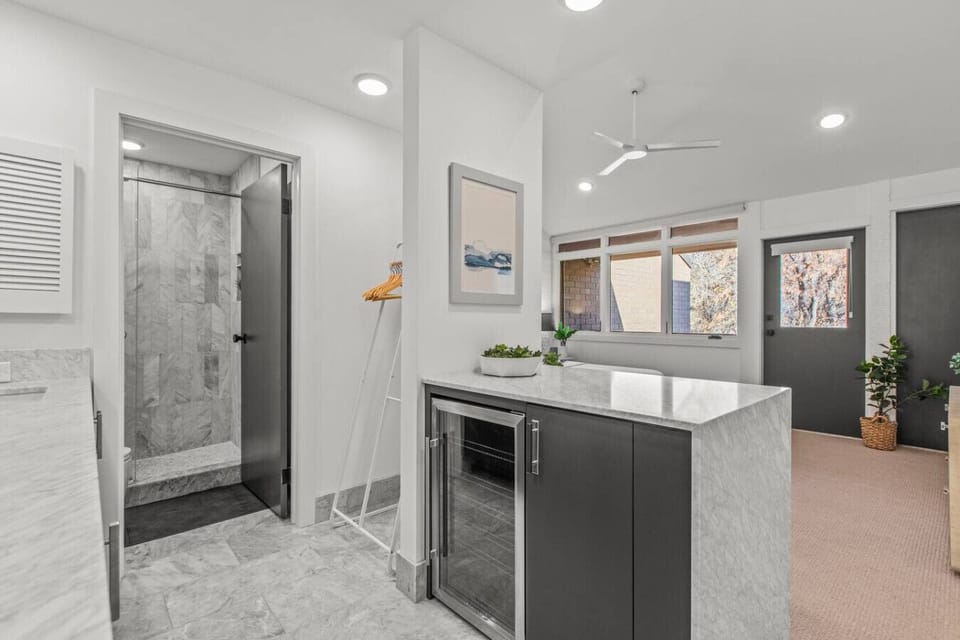 Master ensuite bathroom has private shower and toilet, for convenience and privacy.  Also features a wine/drink cooler and vanity