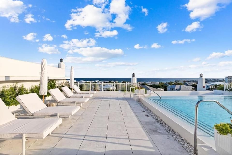 Lounge poolside on plush chaises under wide-open skies.
