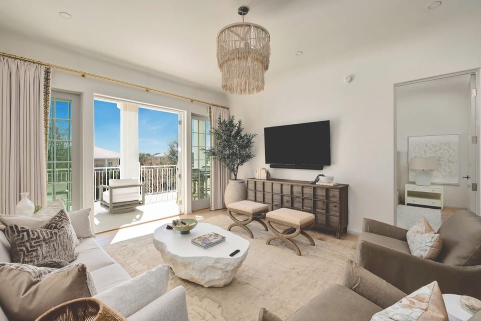 Unwind in a sunlit lounge with breezy balcony views.