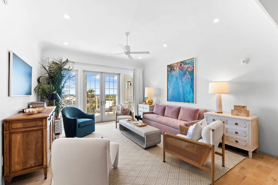 Gather in a sunlit living room with breezy balcony access.