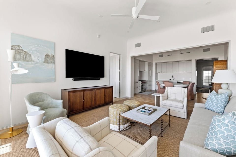 Stretch out on plush seating in a calm, coastal lounge.