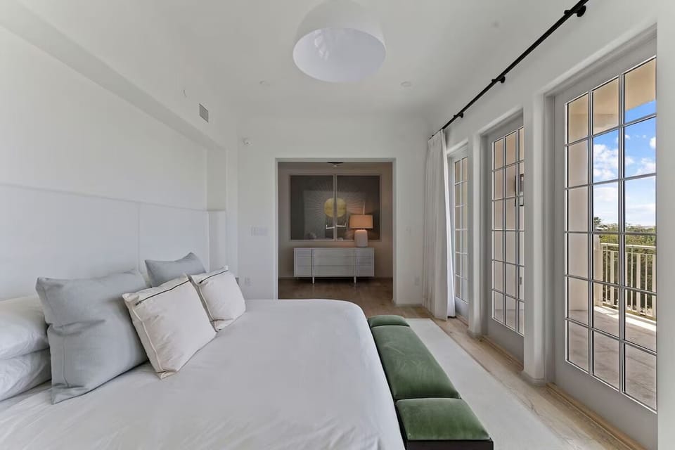 Wake to soft linens and sunshine pouring through French doors