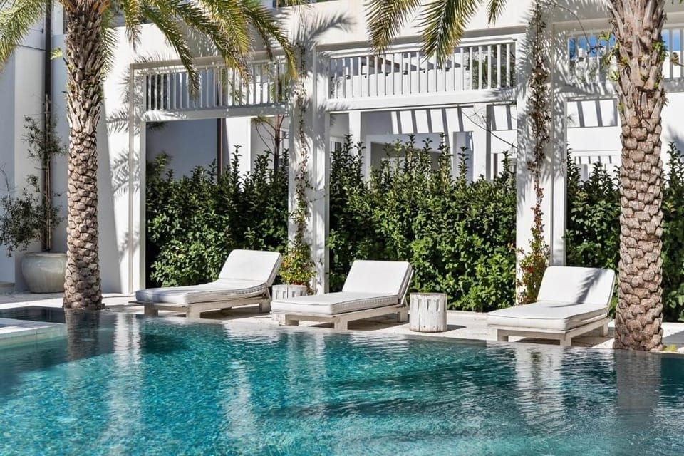 Unwind on in-water daybeds surrounded by swaying palms.