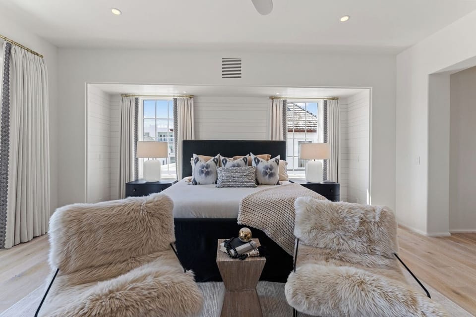 Unwind in the serene primary suite with plush seating.