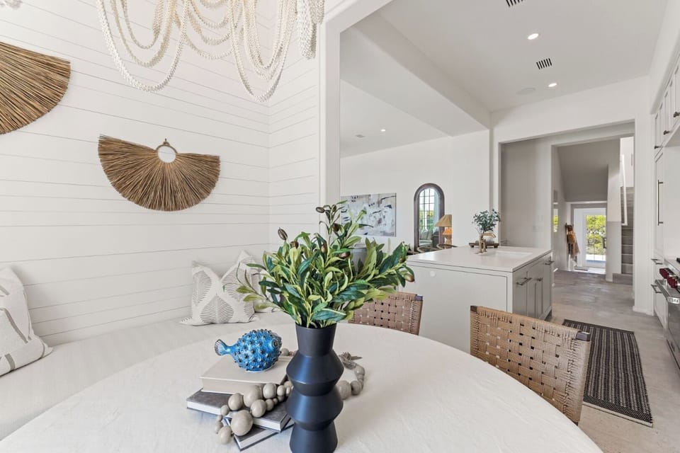 Toast together beneath statement lighting in the open dining area.