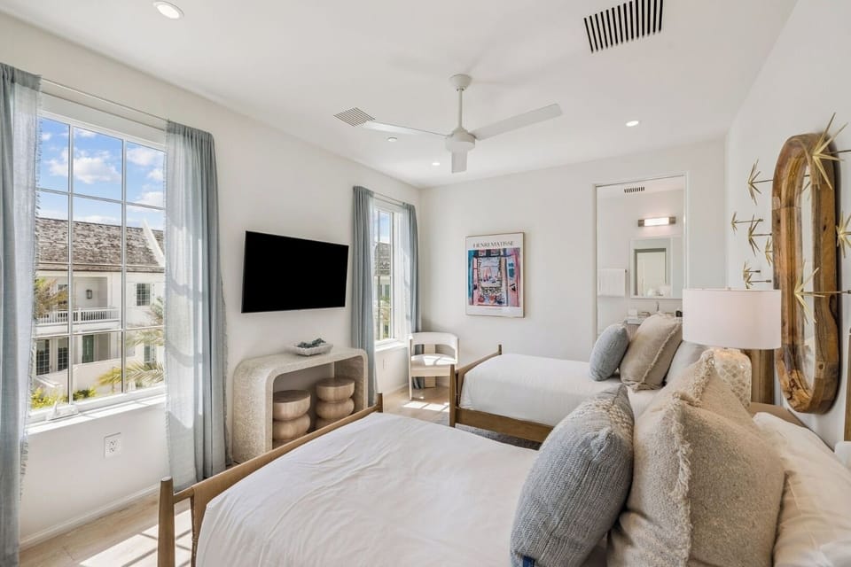 Unwind in sunlit comfort with crisp linens and calming views.