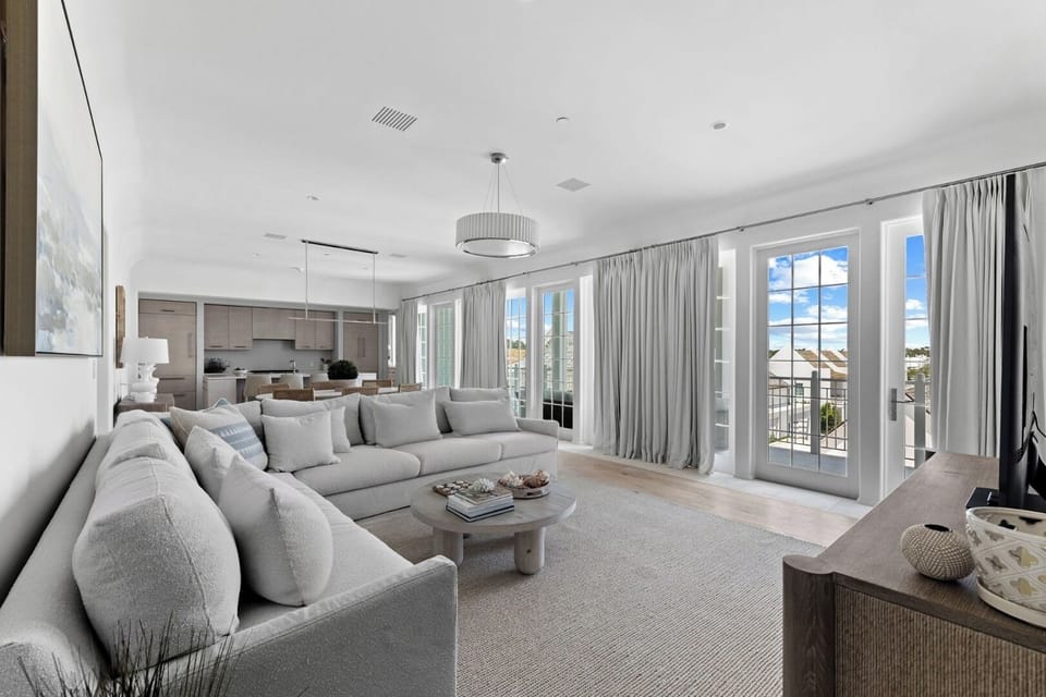 Unwind in the sunlit living room with airy coastal vibes.