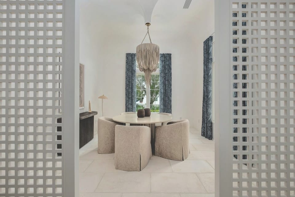 Host memorable dinners beneath statement lighting in serene elegance.