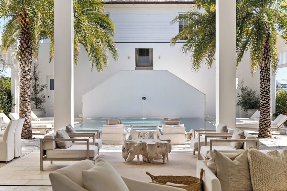 Unwind poolside under palms in a serene private courtyard.