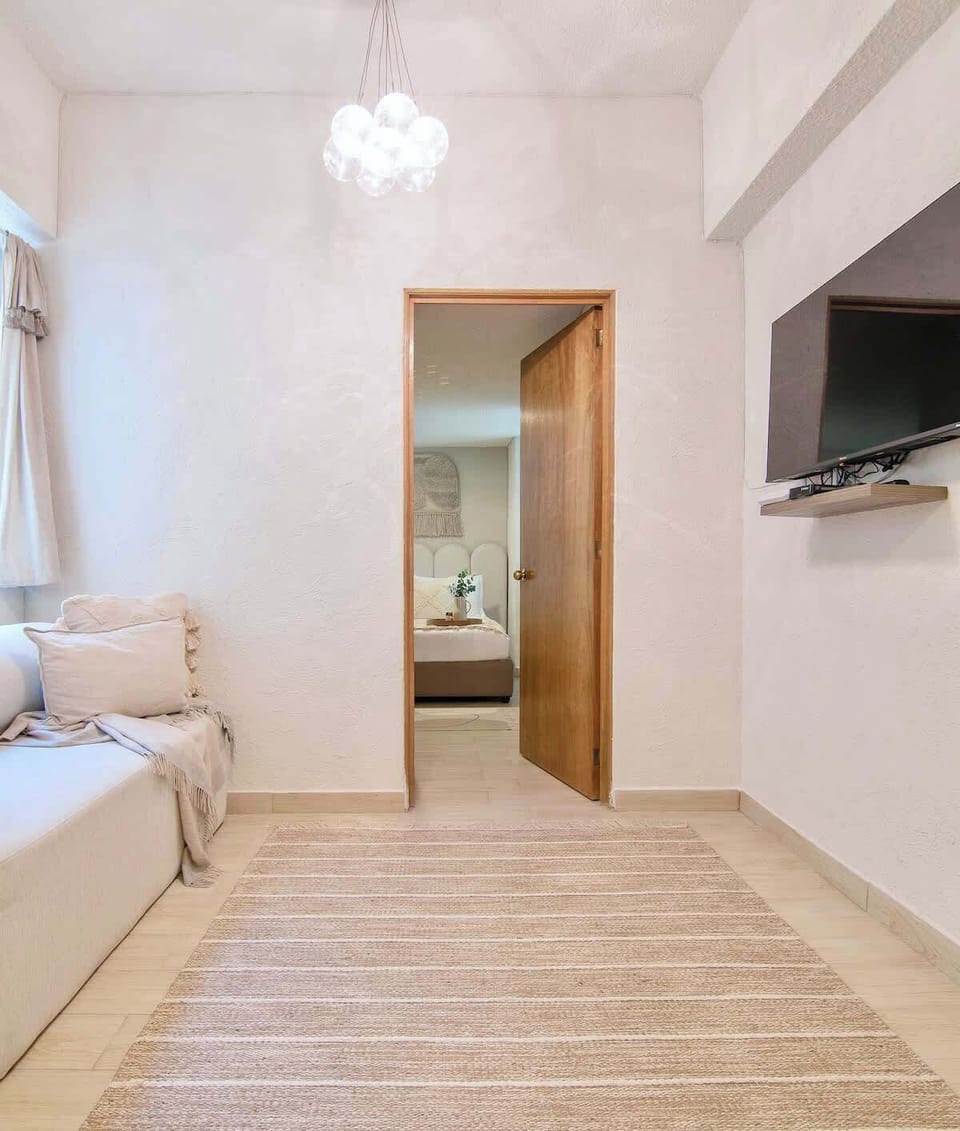 Functional and comfortable space featuring a Smart TV with streaming services, perfect for unwinding with your favorite shows while enjoying a calm and cozy setting.