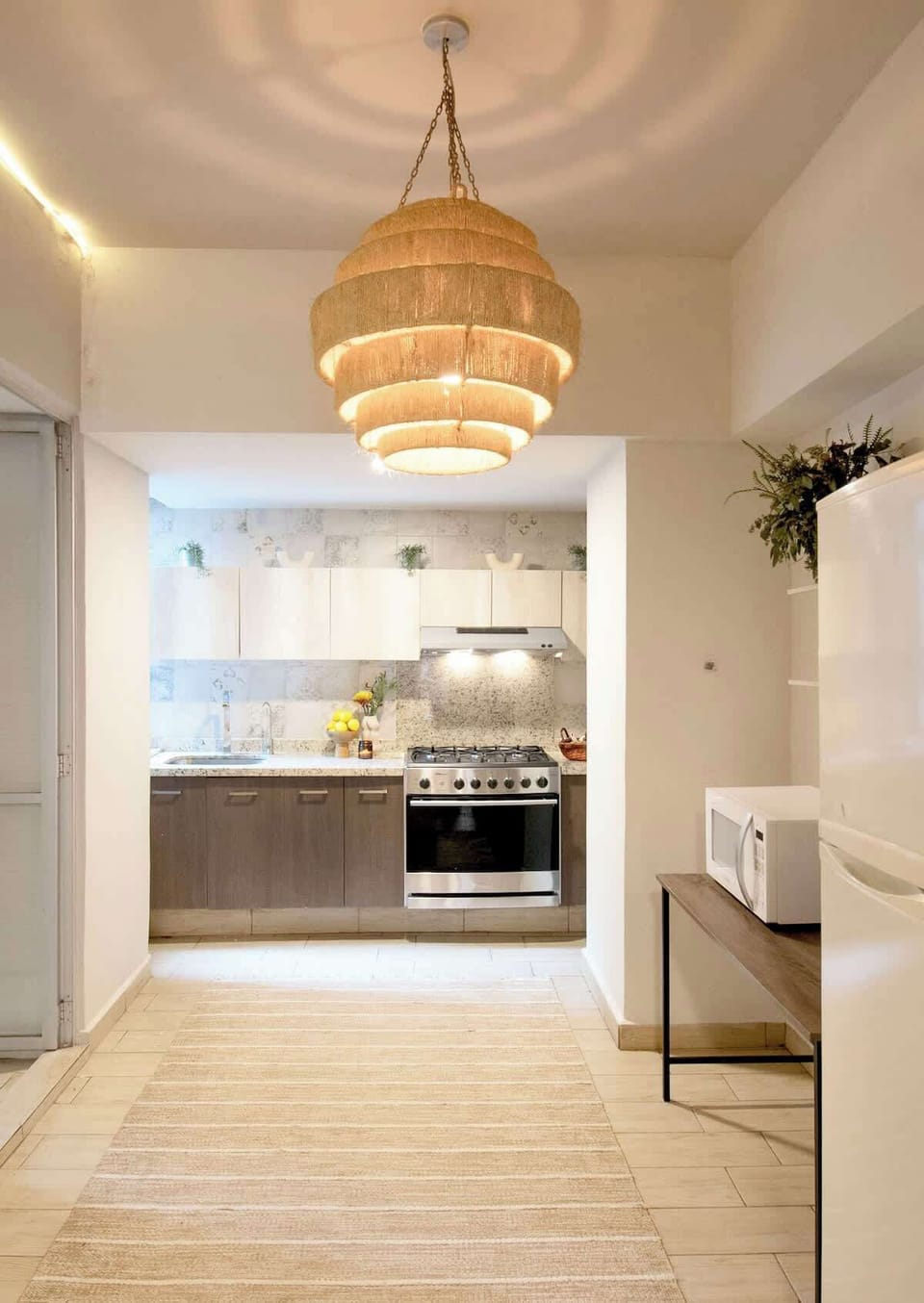 Bright and inviting kitchen space framed by warm lighting and natural textures, creating a welcoming atmosphere for cooking and gathering.
