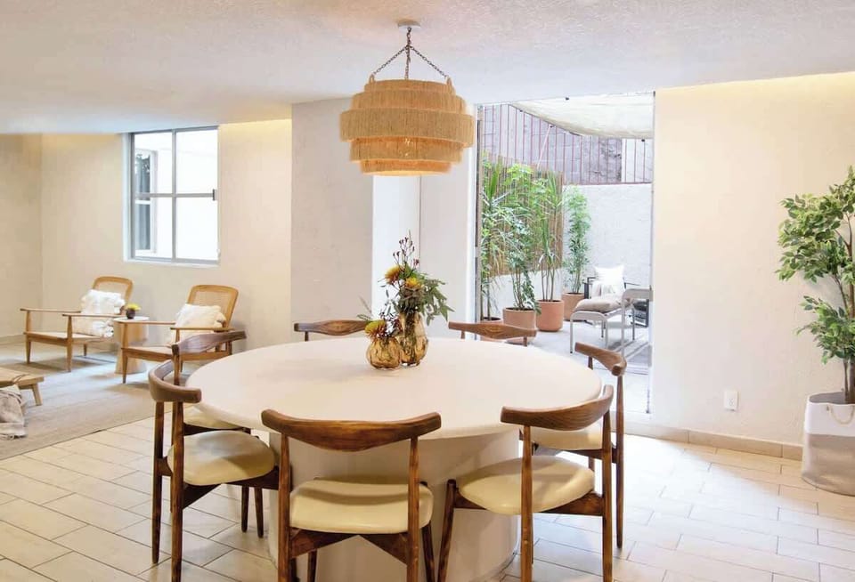 Bright dining area with direct access to an outdoor patio, perfect for enjoying meals with natural light and a refreshing indoor-outdoor connection.