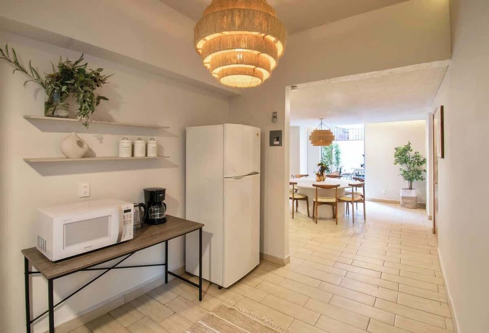 Open kitchen area with refrigerator, coffee maker, and essentials ready for your stay, making it easy to start your mornings just the way you like.