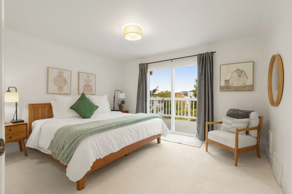 Bright, serene bedroom with private balcony and peaceful outdoor views