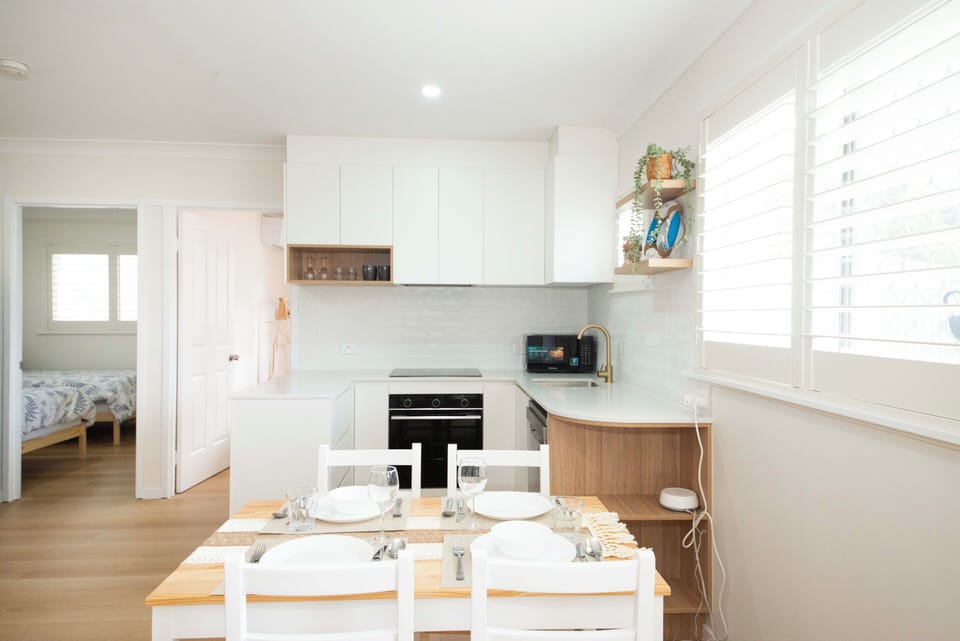 Fully equipped modern kitchen with a warm, inviting dining area.