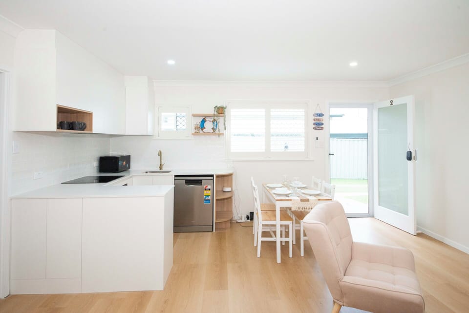 Bright modern kitchen with full amenities and a cozy dining space.