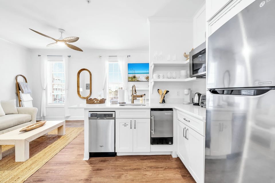 Kitchen in condo features a toaster over, microwave, dishwasher Keurig coffee maker, mini fridge/freezer, and dishes!