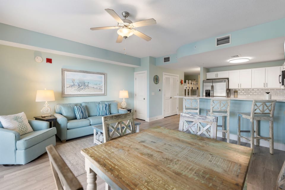 Unwind in your coastal-inspired living space with soothing blue tones, comfortable seating, and a fully equipped kitchen perfect for meal prep.