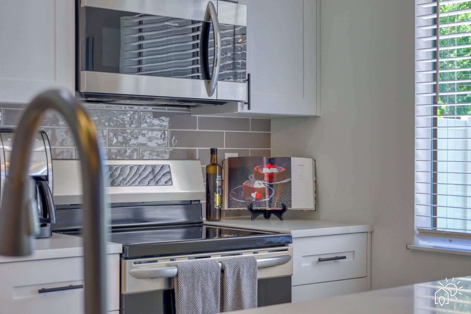 Kitchen: Whip up culinary delights in this modern kitchen with sleek appliances and vibrant decor!