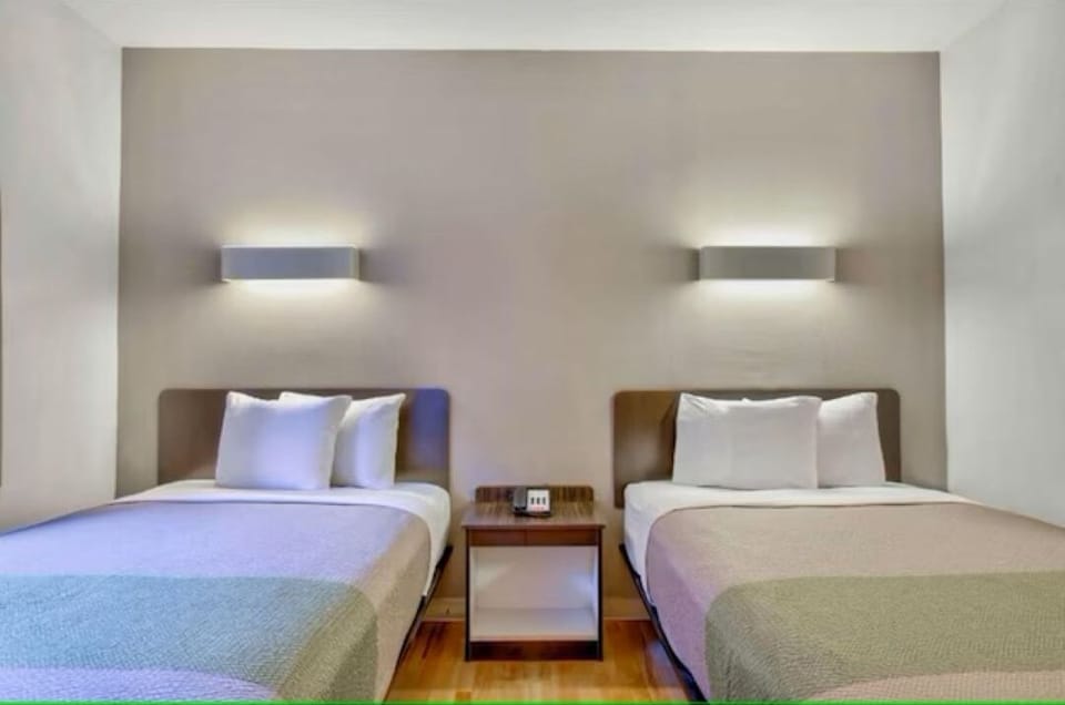 Recharge in crisp bedding with balanced lighting for restful nights.