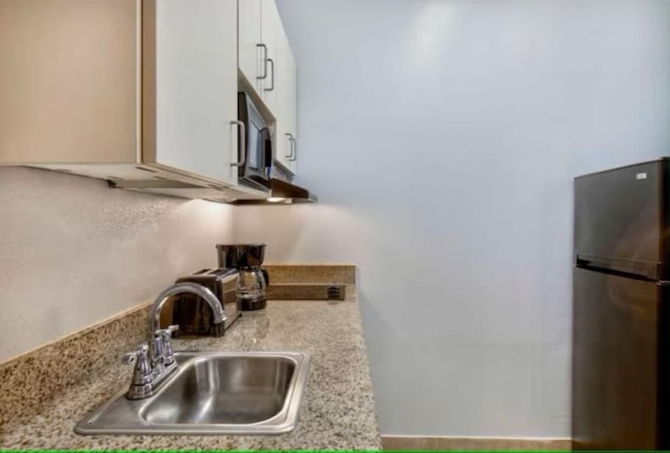 Prep quick snacks with fridge, sink, and handy counter space.