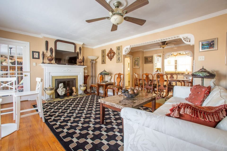 Open living & dining layout with cozy seating and decorative Tiffany-style accent lamps