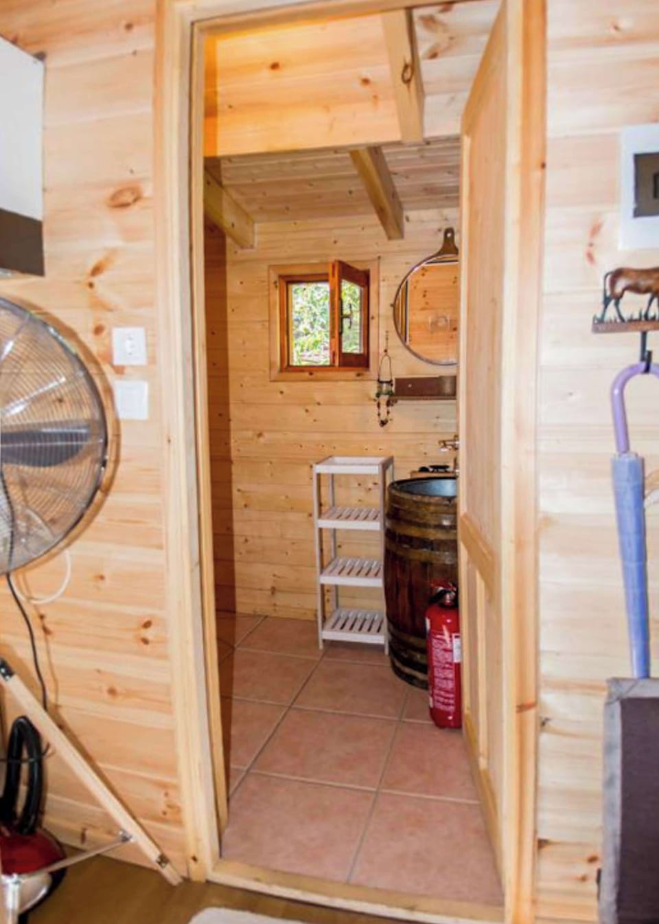 Compact chalet bathroom designed with warm wooden finishes and modern comforts.