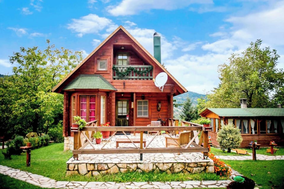 View of the front garden with the warm, wooden chalet in the background.