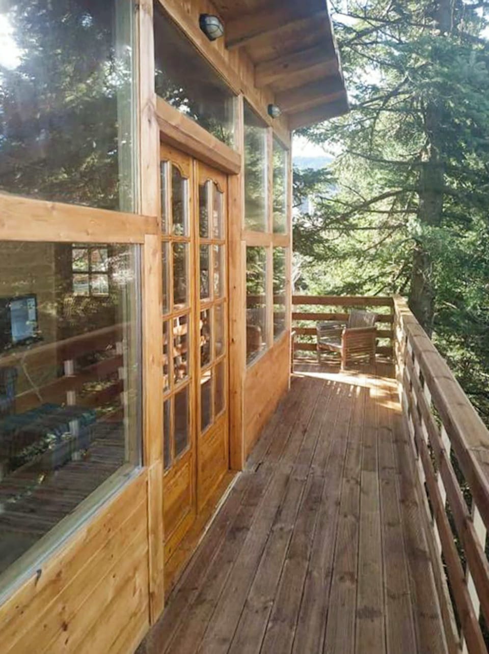 Long wooden balcony leading through the trees.