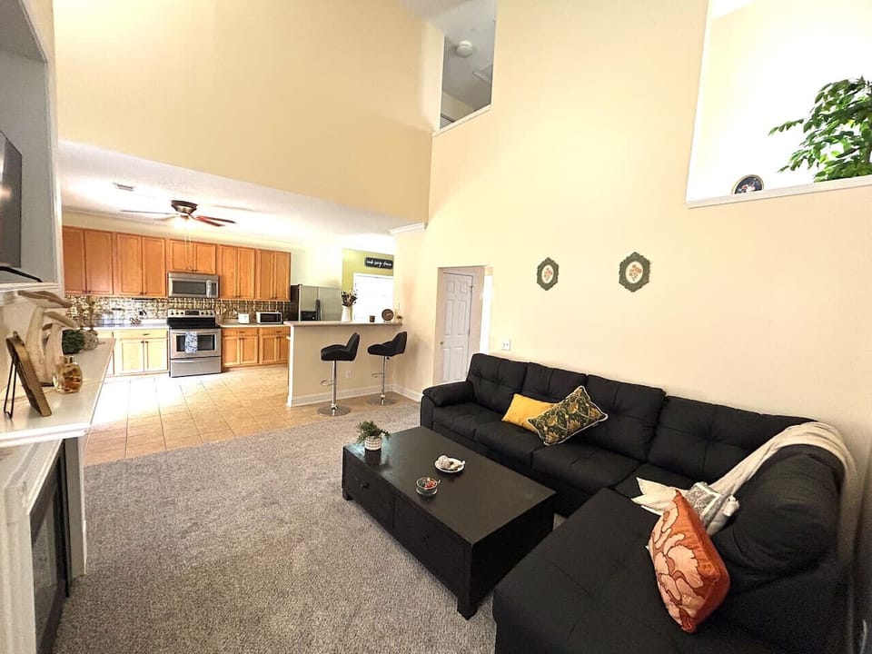 Open-concept design with high ceilings brings together kitchen, dining, and living spaces for easy gatherings.
