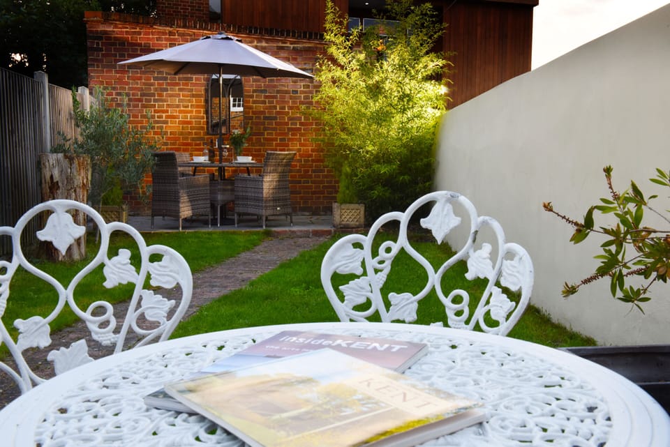 Private garden with outdoor dining, ideal for al fresco meals and summer evenings.