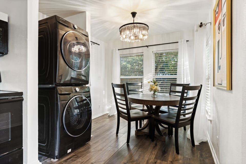 A well-appointed laundry room and pantry featuring brand-new front-load 