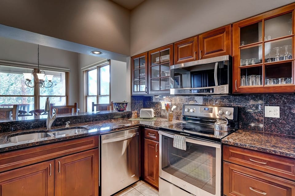 Cook up hearty meals in the full kitchen, featuring granite countertops, stainless appliances, and everything you need for your stay.