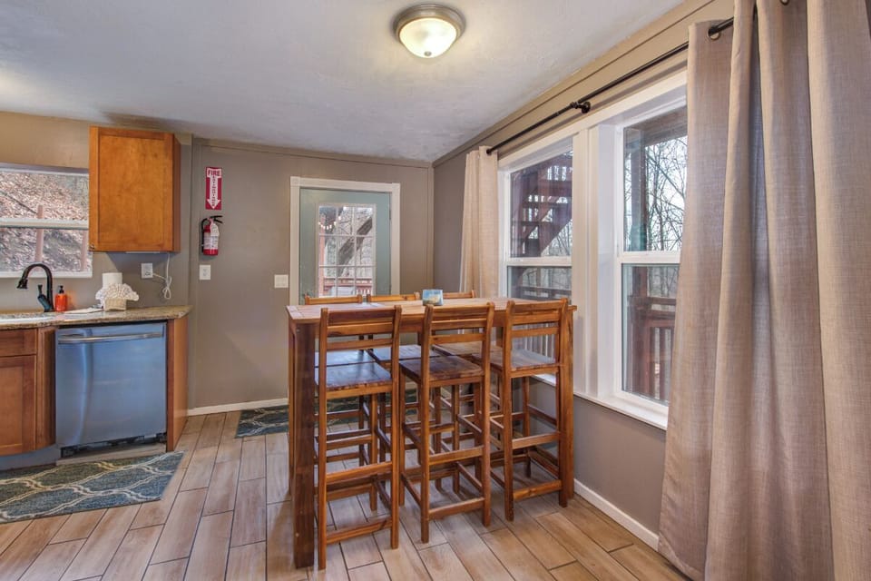 Gather around this cozy dining space where warm wood tones meet modern convenience, perfect for sharing meals with your travel companions.