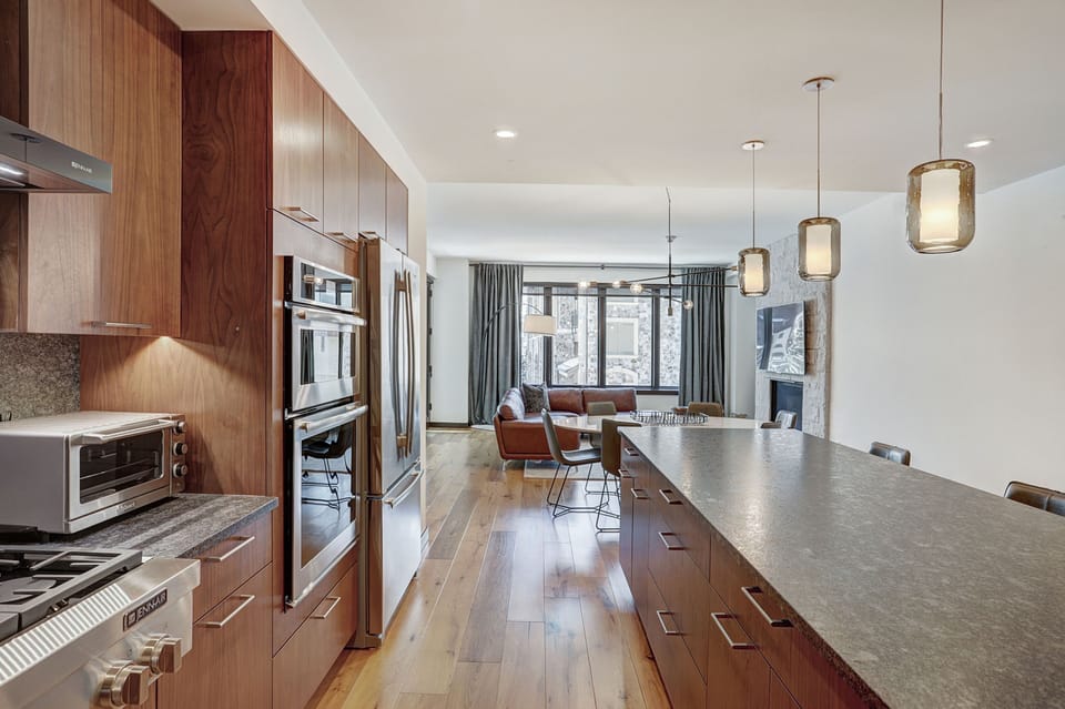 Expansive island stretching through the kitchen, perfect for preparing meals or gathering with friends.