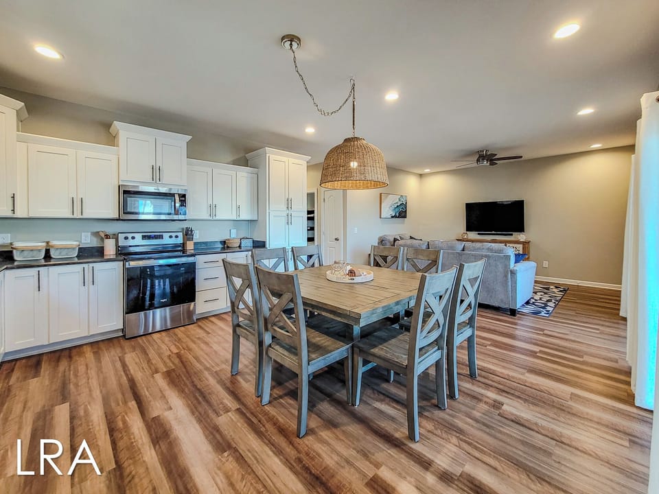 Your open-concept space flows beautifully from modern kitchen to dining area to cozy living room, perfect for group gatherings and memorable meals together.