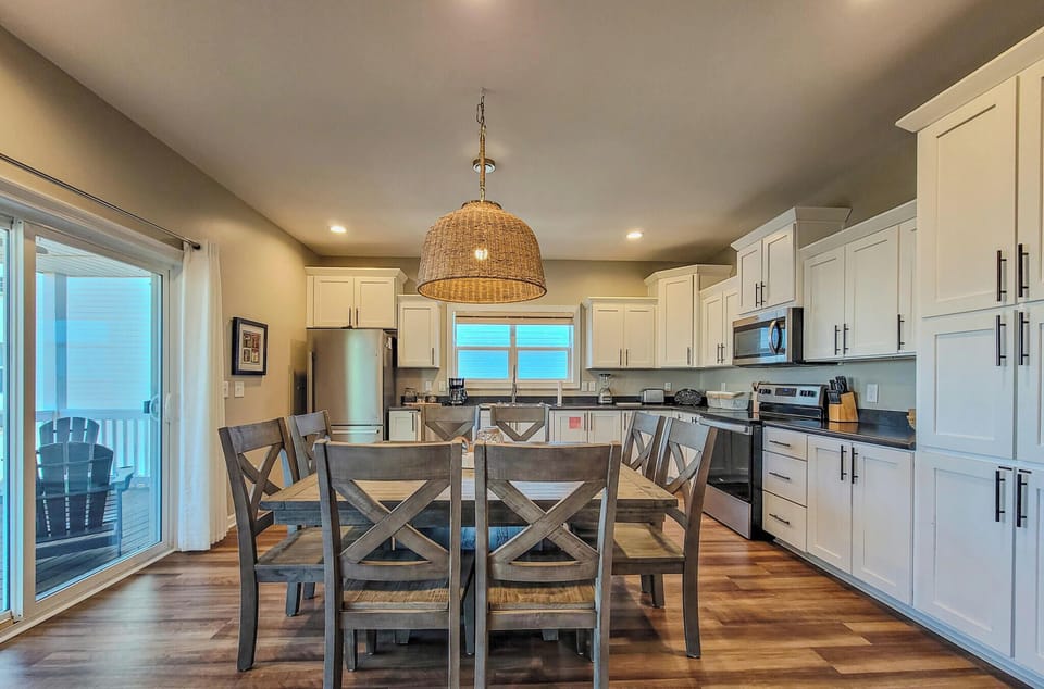 Your open-concept kitchen flows seamlessly into dining, perfect for gathering around meals while natural light streams through sliding doors to your private balcony.