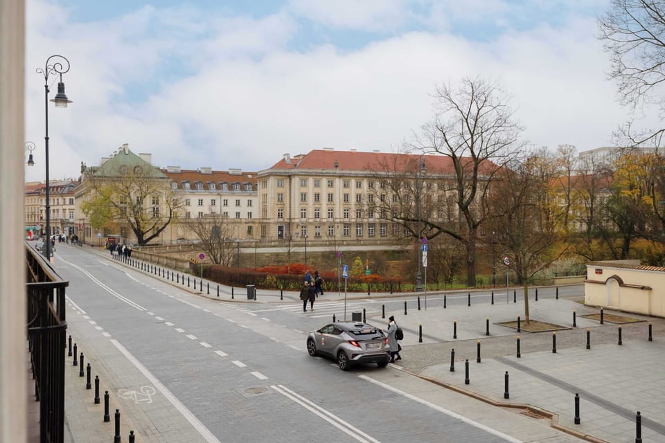The view of the nearby square and distinctive buildings brings a lively urban rhythm, offering a charming setting perfect for strolling and exploring the area.