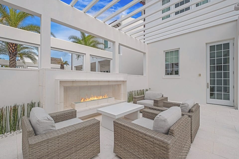 Toast evenings by the modern fire feature under open skies.