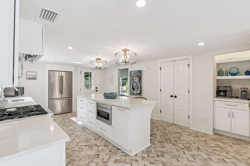 Your spacious kitchen awaits with gleaming countertops, modern appliances, and a charming island perfect for morning coffee or evening meal prep.