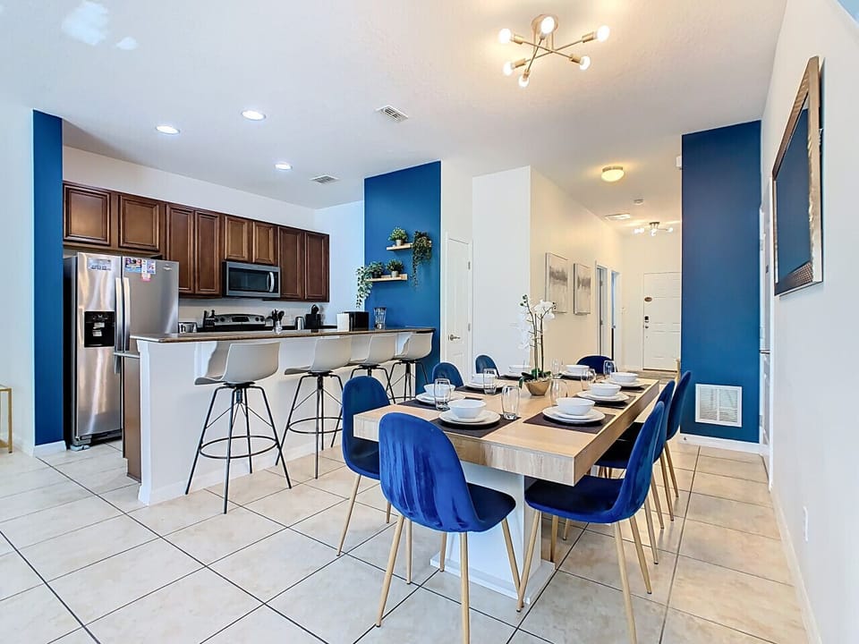 Inviting dining space with stylish blue chairs and a clean, modern design.