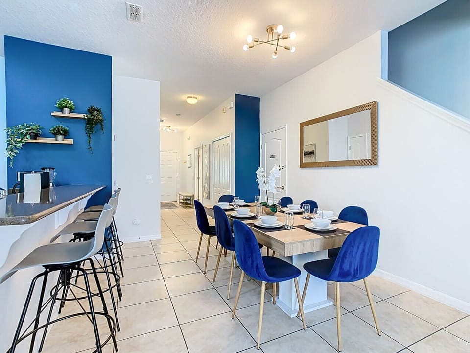 Inviting dining space with stylish blue chairs and a clean, modern design.