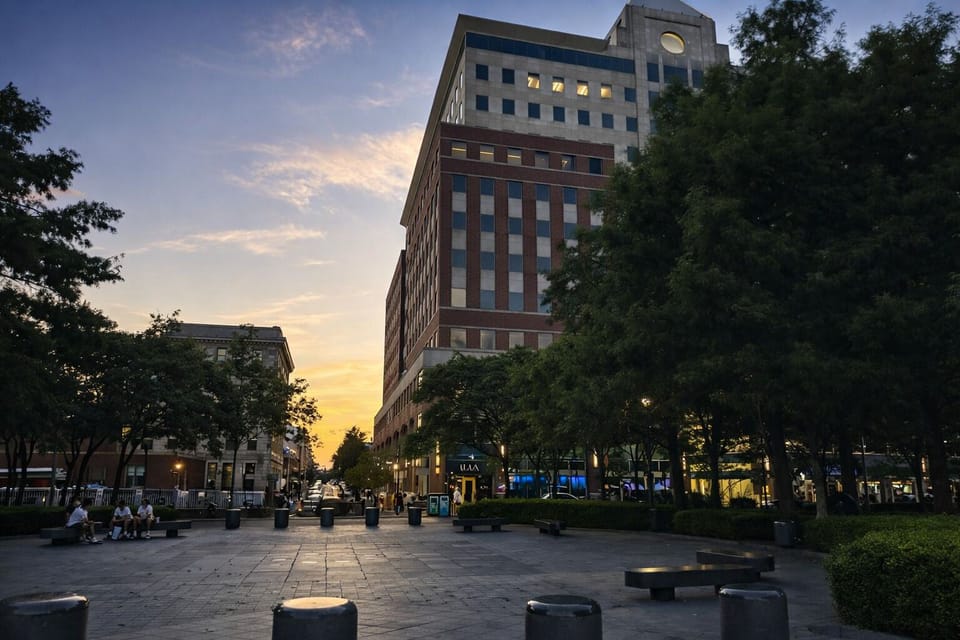 Sunset plaza by dining, shops, and transit—walkable city hub.
