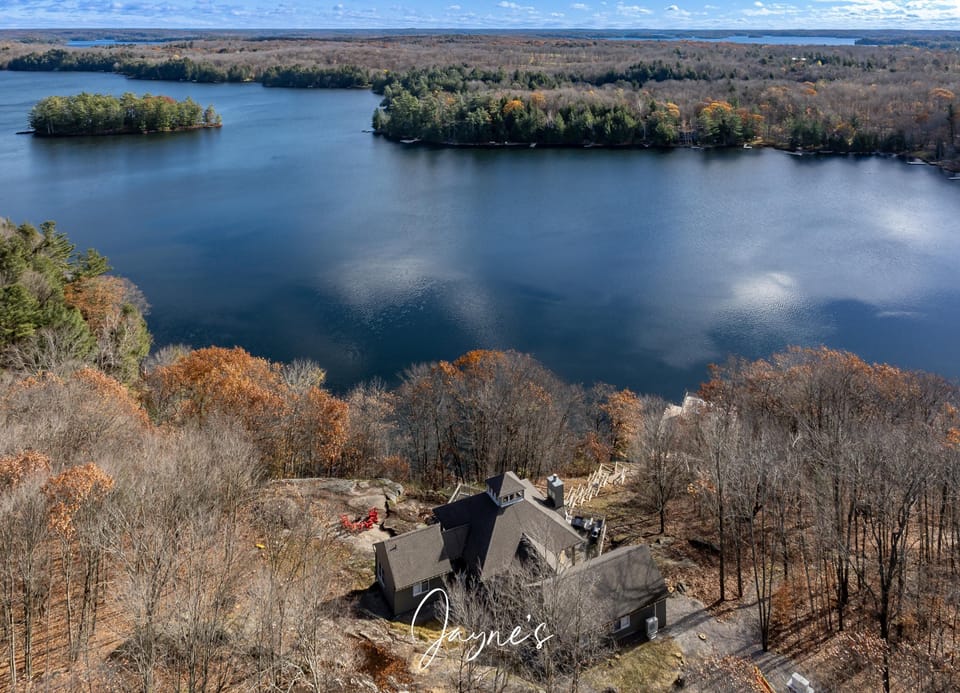 Secluded lakeside retreat surrounded by tranquil autumn woods