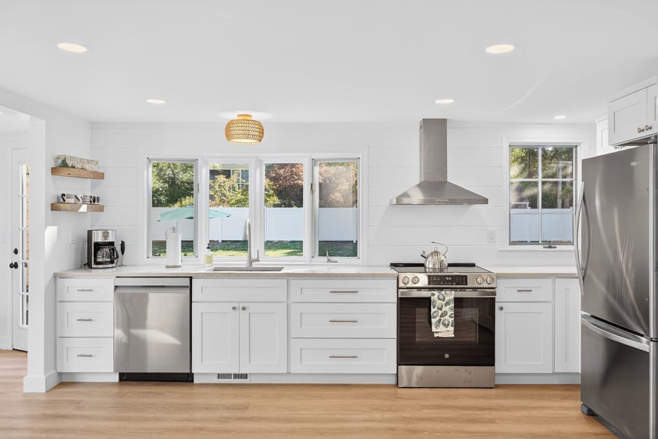 Renovated kitchen with fridge with icemaker, dishwasher, stove, microwave
